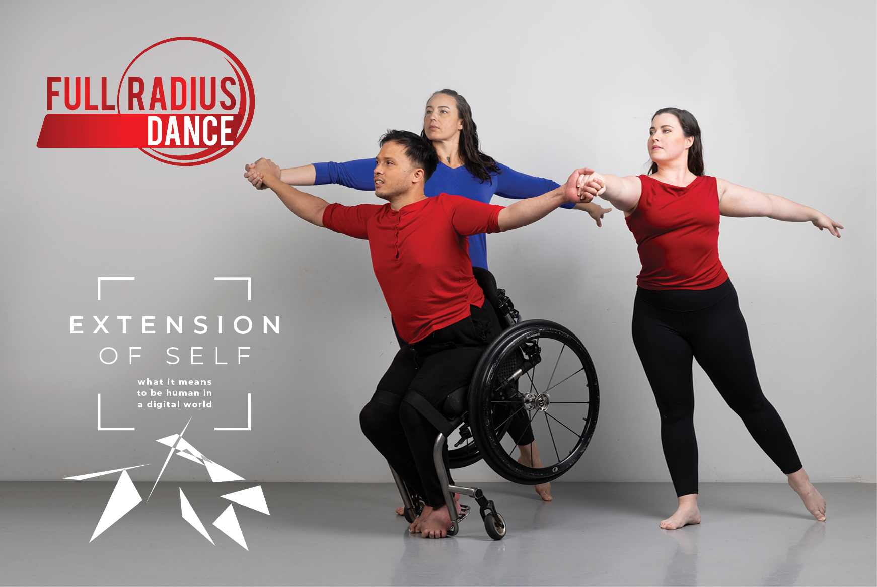 (From left to right) Ashlee Jo Ramsey-Borunov, Peter L. Trojic in his wheelchair and Courtney Michelle McClendon of Full Radius Dance are in a posed studio portrait. Ramsey-Borunov and McClendon hold onto Trojic’s hands as he executes a front tilt with his footplate touching the floor and his wheels off the floor. Trojic and McClendon are both clad in cherry-red shirts — three-quarter length sleeves and sleeveless, respectively — and black leggings. Ramsey-Borunov has a deep blue shirt with three-quar