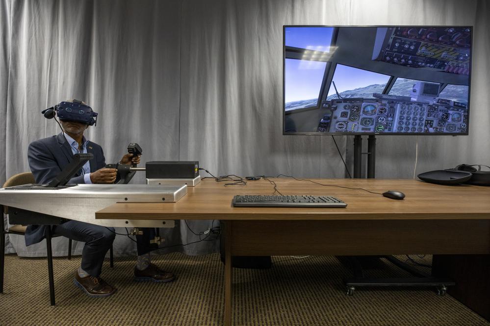 A researcher holding a VR headset.