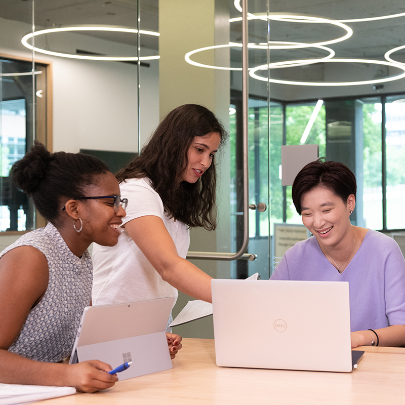 Georgia Tech students working as a team. Two looking at a computer.